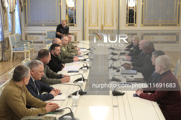 US Secretary of Defense Lloyd Austin and President of Ukraine Volodymyr Zelenskyy sit at the table across from each other during the meeting...