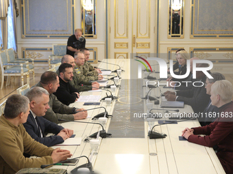 US Secretary of Defense Lloyd Austin and President of Ukraine Volodymyr Zelenskyy sit at the table across from each other during the meeting...