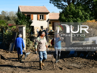 Several volunteers and residents participate in the restoration of the village of Limony in Ardeche, France, on October 21, 2024, after the...