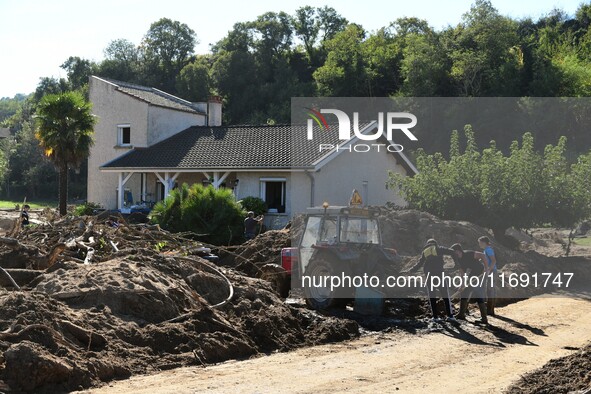 Several volunteers and residents participate in the restoration of the village of Limony in Ardeche, France, on October 21, 2024, after the...