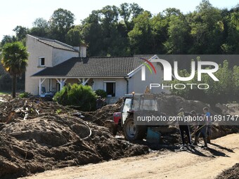 Several volunteers and residents participate in the restoration of the village of Limony in Ardeche, France, on October 21, 2024, after the...