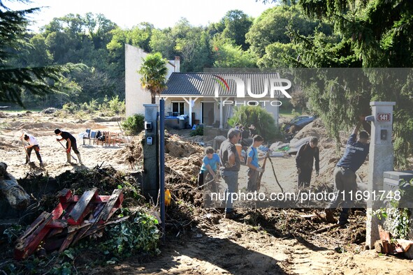 Several volunteers and residents participate in the restoration of the village of Limony in Ardeche, France, on October 21, 2024, after the...