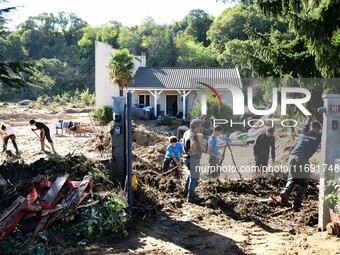 Several volunteers and residents participate in the restoration of the village of Limony in Ardeche, France, on October 21, 2024, after the...