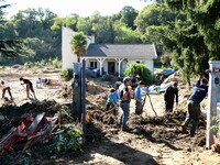 Several volunteers and residents participate in the restoration of the village of Limony in Ardeche, France, on October 21, 2024, after the...