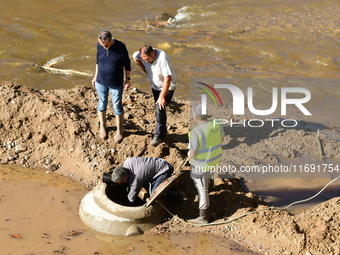 Several volunteers and residents participate in the restoration of the village of Limony in Ardeche, France, on October 21, 2024, after the...