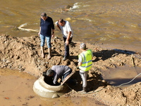 Several volunteers and residents participate in the restoration of the village of Limony in Ardeche, France, on October 21, 2024, after the...