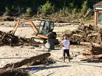 Several volunteers and residents participate in the restoration of the village of Limony in Ardeche, France, on October 21, 2024, after the...