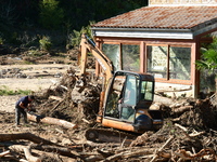 Several volunteers and residents participate in the restoration of the village of Limony in Ardeche, France, on October 21, 2024, after the...