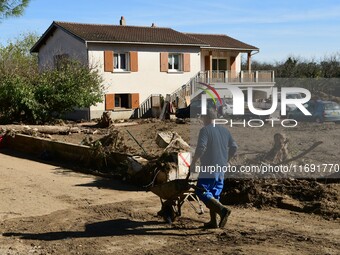 Several volunteers and residents participate in the restoration of the village of Limony in Ardeche, France, on October 21, 2024, after the...