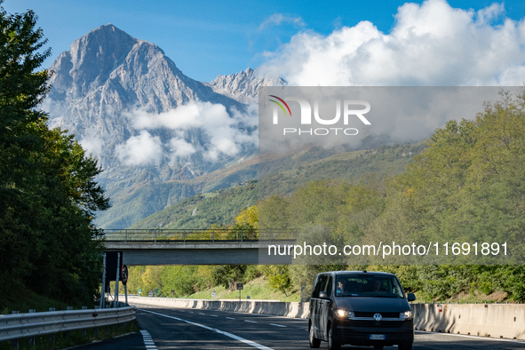 A vehicle crossing A24 highway is seen in the province of Teramo, Italy, on October 12th, 2024. Gran Sasso peaks (Corno Grande and Corno Pic...