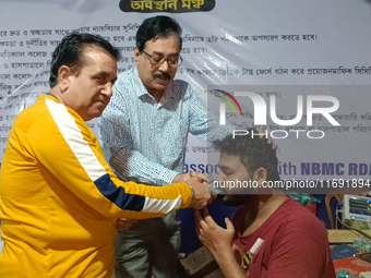 Dr. Sandip Mandal, a second-year PGT in the Orthopaedic department, drinks water to break his hunger strike protest on the eighth day of his...