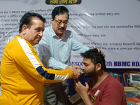 Dr. Sandip Mandal, a second-year PGT in the Orthopaedic department, drinks water to break his hunger strike protest on the eighth day of his...