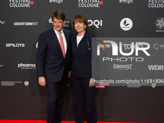 Henriette Reker, the mayor of Cologne, and Leopold Hoesch, the film producer, are seen on the red carpet during the photocall of ''Die Unbeu...