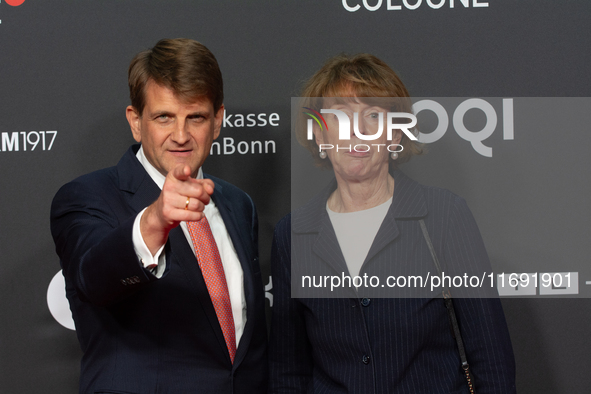 Henriette Reker, the mayor of Cologne, and Leopold Hoesch, the film producer, are seen on the red carpet during the photocall of ''Die Unbeu...