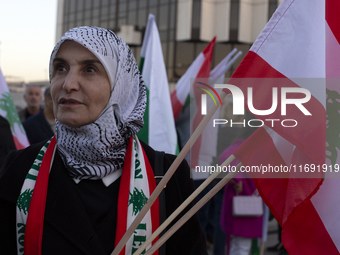 Demonstrators wave flags of Lebanon and Palestine during a rally titled 'Give Peace a Chance' in Sofia, Bulgaria, on October 21, 2024, again...