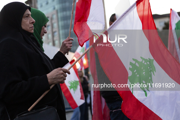 Demonstrators wave flags of Lebanon and Palestine during a rally titled 'Give Peace a Chance' in Sofia, Bulgaria, on October 21, 2024, again...