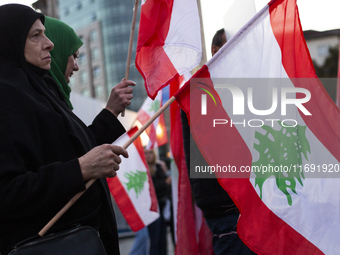 Demonstrators wave flags of Lebanon and Palestine during a rally titled 'Give Peace a Chance' in Sofia, Bulgaria, on October 21, 2024, again...