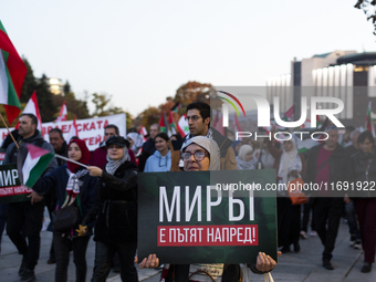 Demonstrators wave flags of Lebanon and Palestine during a rally titled 'Give Peace a Chance' in Sofia, Bulgaria, on October 21, 2024, again...