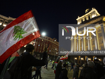 Demonstrators wave flags of Lebanon and Palestine during a rally titled 'Give Peace a Chance' in Sofia, Bulgaria, on October 21, 2024, again...