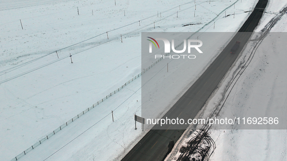 Heavy snow brought by strong cold air falls on the north slope of Tianshan Mountain in Hami, China, on October 20, 2024. 