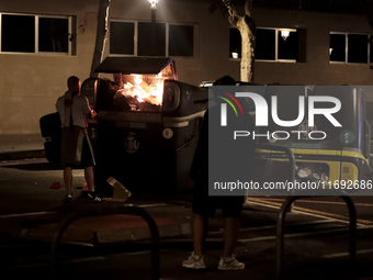 Several Valencia CF ultras confront the police by throwing objects and burning rubbish containers after losing against UD Las Palmas in a La...