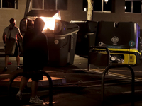 Several Valencia CF ultras confront the police by throwing objects and burning rubbish containers after losing against UD Las Palmas in a La...