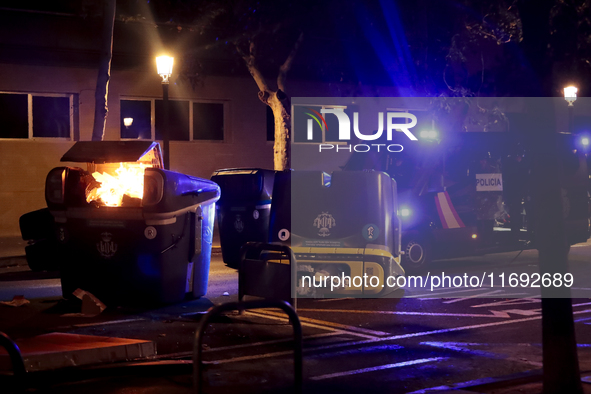 Several Valencia CF ultras confront the police by throwing objects and burning rubbish containers after losing against UD Las Palmas in a La...