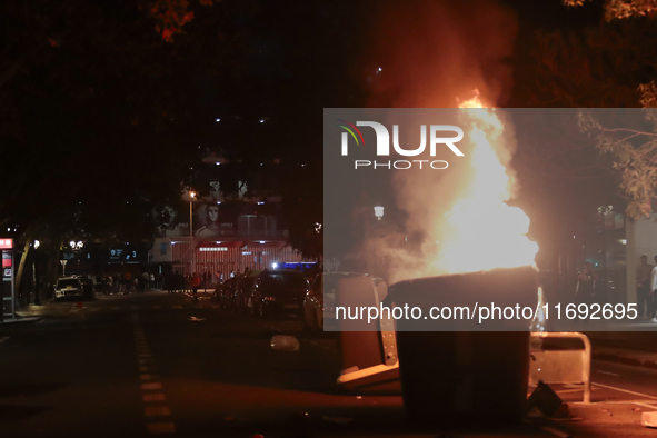 Several Valencia CF ultras confront the police by throwing objects and burning rubbish containers after losing against UD Las Palmas in a La...