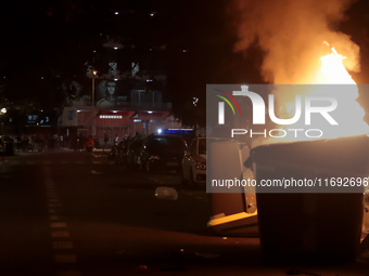 Several Valencia CF ultras confront the police by throwing objects and burning rubbish containers after losing against UD Las Palmas in a La...