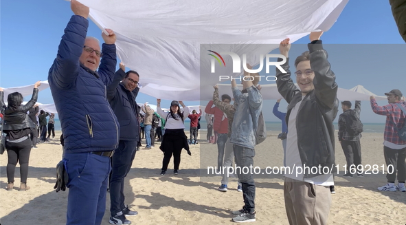 Greenpeace volunteers work on the beach with the students of the Fermi-Nervi-Cassandro Institute to say stop to single-use plastic in Barlet...