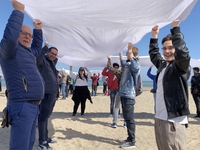 Greenpeace volunteers work on the beach with the students of the Fermi-Nervi-Cassandro Institute to say stop to single-use plastic in Barlet...