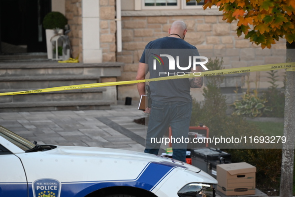 Investigators from the Peel Regional Police search for evidence at the scene of a home invasion in Brampton, Canada, on October 21, 2024. On...