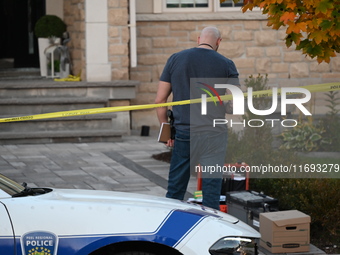 Investigators from the Peel Regional Police search for evidence at the scene of a home invasion in Brampton, Canada, on October 21, 2024. On...