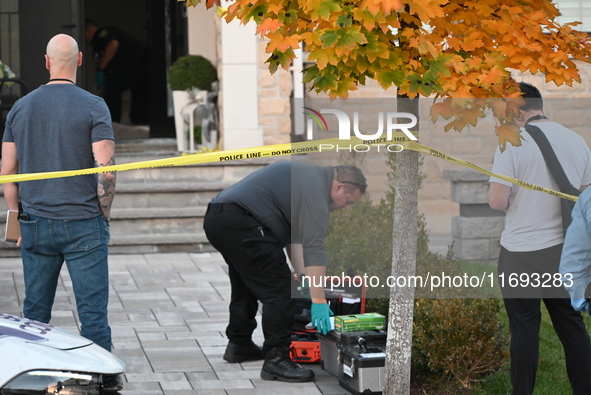 Investigators from the Peel Regional Police search for evidence at the scene of a home invasion in Brampton, Canada, on October 21, 2024. On...