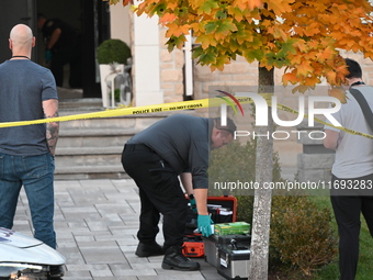 Investigators from the Peel Regional Police search for evidence at the scene of a home invasion in Brampton, Canada, on October 21, 2024. On...