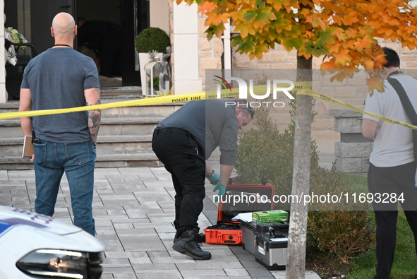 Investigators from the Peel Regional Police search for evidence at the scene of a home invasion in Brampton, Canada, on October 21, 2024. On...