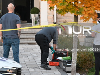 Investigators from the Peel Regional Police search for evidence at the scene of a home invasion in Brampton, Canada, on October 21, 2024. On...