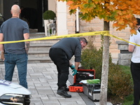 Investigators from the Peel Regional Police search for evidence at the scene of a home invasion in Brampton, Canada, on October 21, 2024. On...