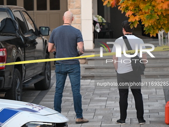 Investigators from the Peel Regional Police search for evidence at the scene of a home invasion in Brampton, Canada, on October 21, 2024. On...