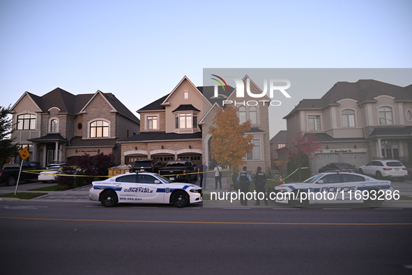 Investigators from the Peel Regional Police search for evidence at the scene of a home invasion in Brampton, Canada, on October 21, 2024. On...