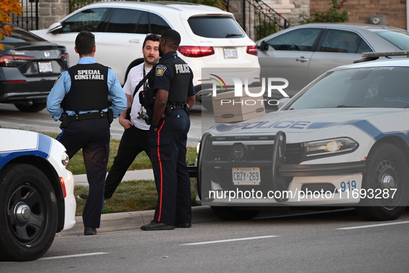 Investigators from the Peel Regional Police search for evidence at the scene of a home invasion in Brampton, Canada, on October 21, 2024. On...