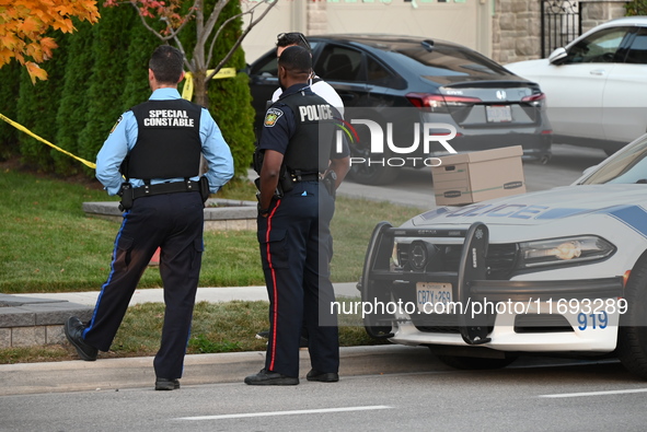 Investigators from the Peel Regional Police search for evidence at the scene of a home invasion in Brampton, Canada, on October 21, 2024. On...