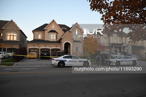 Investigators from the Peel Regional Police search for evidence at the scene of a home invasion in Brampton, Canada, on October 21, 2024. On...