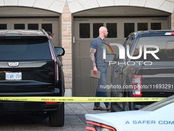 Investigators from the Peel Regional Police search for evidence at the scene of a home invasion in Brampton, Canada, on October 21, 2024. On...