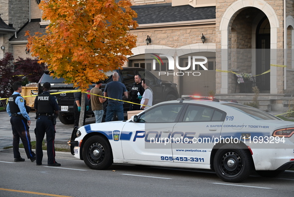 Investigators from the Peel Regional Police search for evidence at the scene of a home invasion in Brampton, Canada, on October 21, 2024. On...