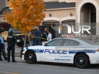 Investigators from the Peel Regional Police search for evidence at the scene of a home invasion in Brampton, Canada, on October 21, 2024. On...