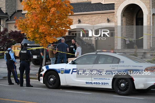 Investigators from the Peel Regional Police search for evidence at the scene of a home invasion in Brampton, Canada, on October 21, 2024. On...