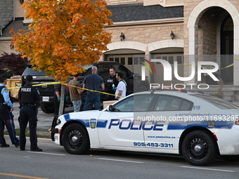 Investigators from the Peel Regional Police search for evidence at the scene of a home invasion in Brampton, Canada, on October 21, 2024. On...