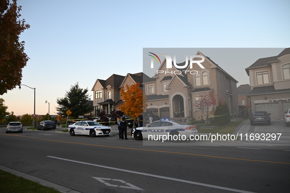 Investigators from the Peel Regional Police search for evidence at the scene of a home invasion in Brampton, Canada, on October 21, 2024. On...