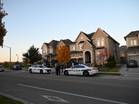 Investigators from the Peel Regional Police search for evidence at the scene of a home invasion in Brampton, Canada, on October 21, 2024. On...